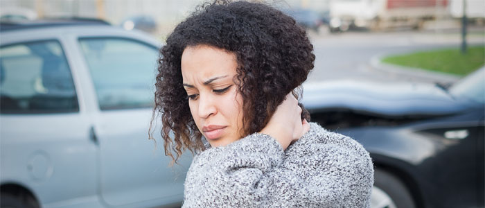 Woman holding neck in pain after a car accident